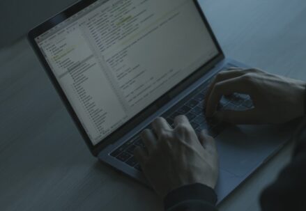 Person coding on a laptop
